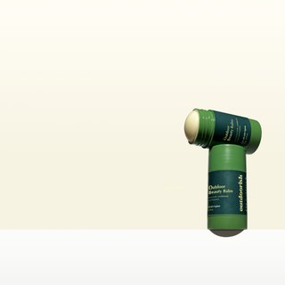 Outdoor Beauty Balm stick, uncapped, showing the solid balm